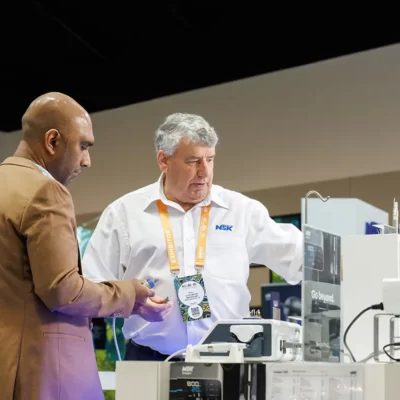 Two delegates looking at dental equipment at the World Dental Congress exhibition at Sydney ICC