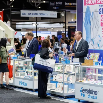 Delegates and exhibitors talking at a exhibition stand at the dental congress